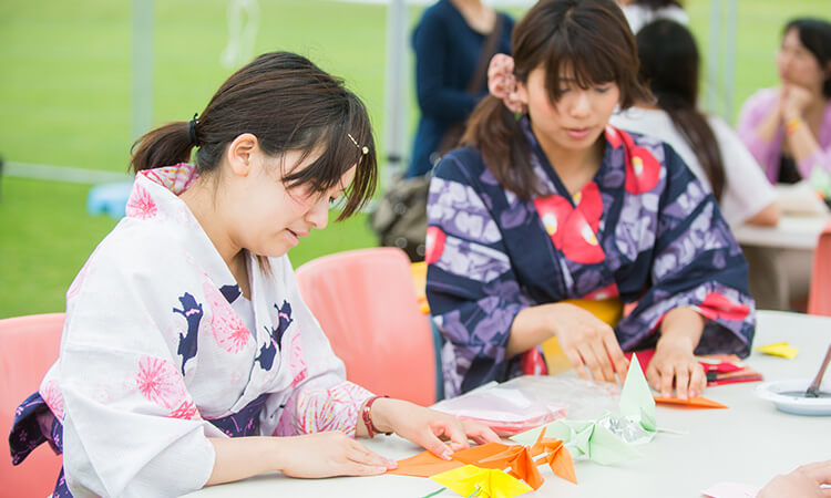 two girls creating oragami