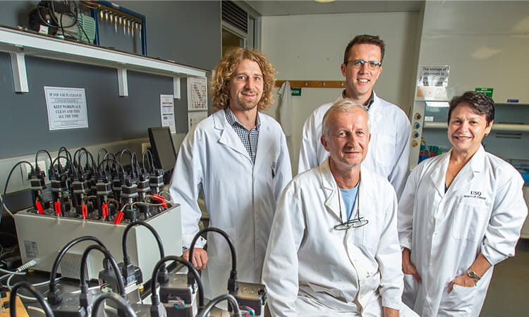 Four USQ researchers in a lab