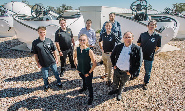 usq researchers standing with space equipment
