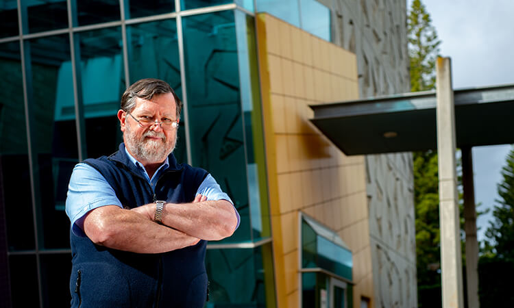 andreas helwig standing by building at usq