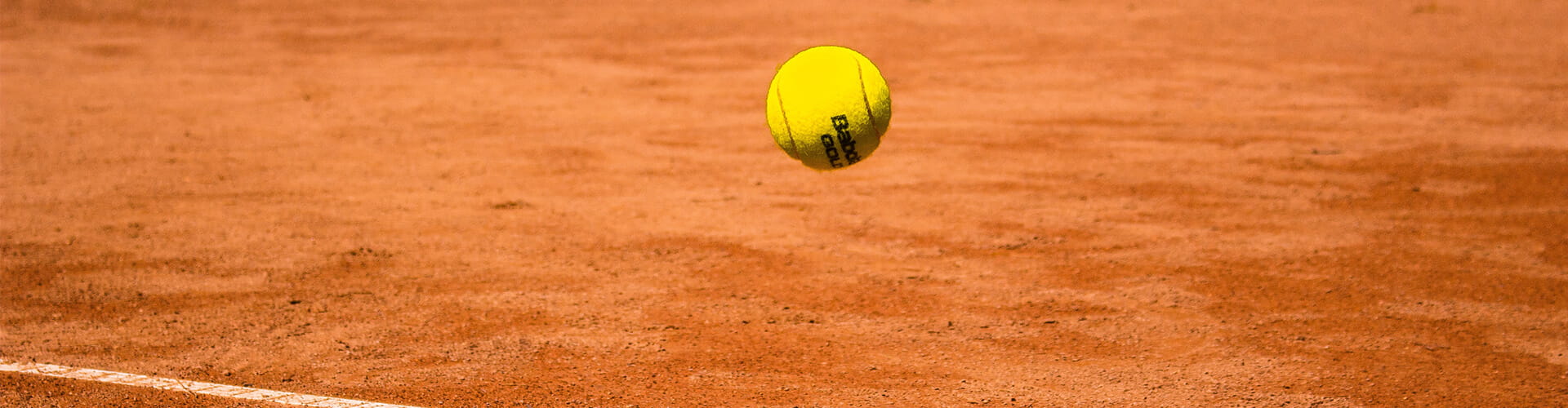 tennis ball on clay court