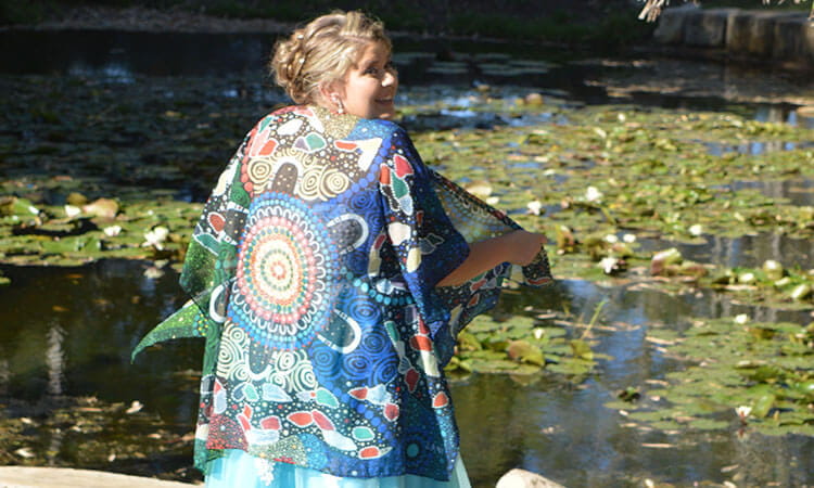 usq student makayla smiling near a pond