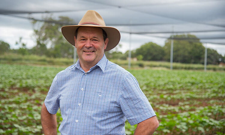 man in field smiling 