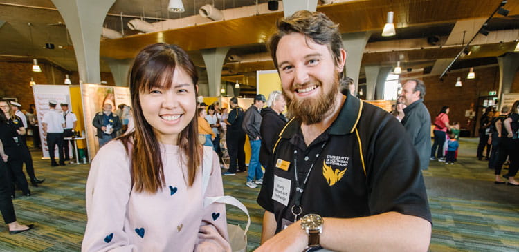 USQ staff member and international student smiling at the camera.