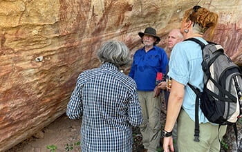 USQ archaeologists observing historical rock art